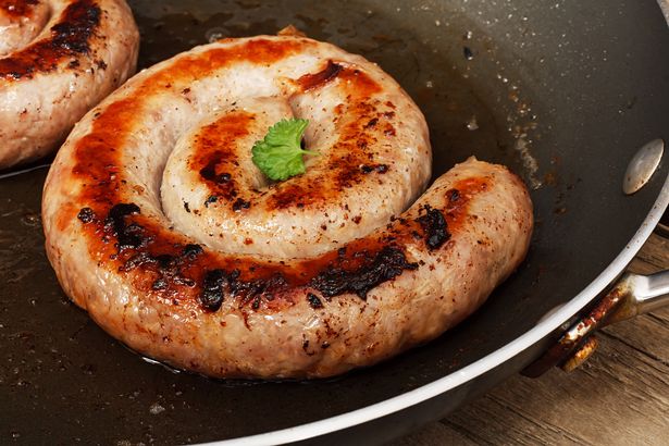 Image of Cumberland sausage frying in a pan