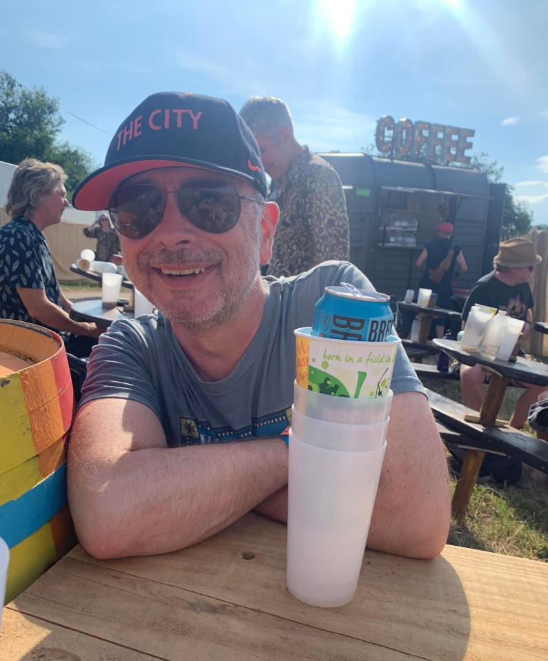 Man at a festival with drinks.