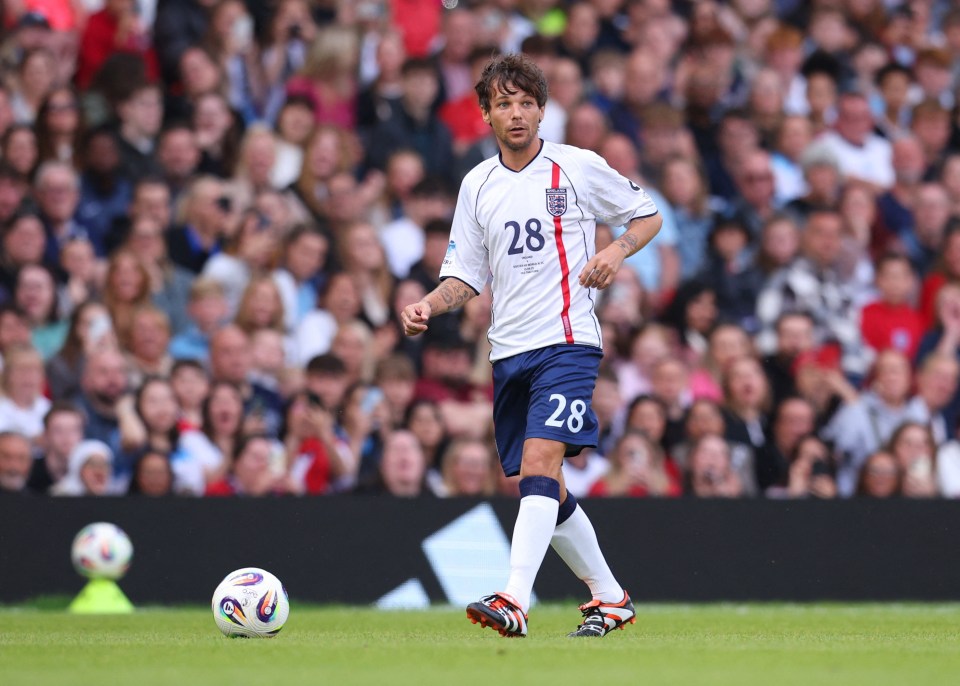 Louis Tomlinson playing soccer in a charity match.
