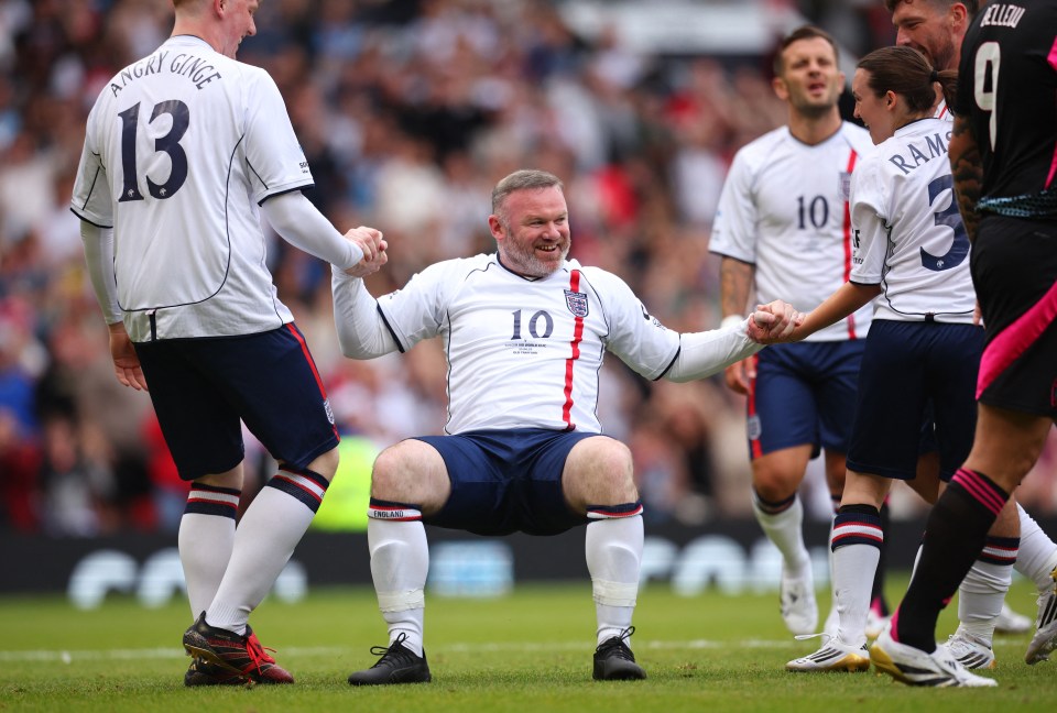 Wayne Rooney celebrating a goal at a Soccer Aid charity match.