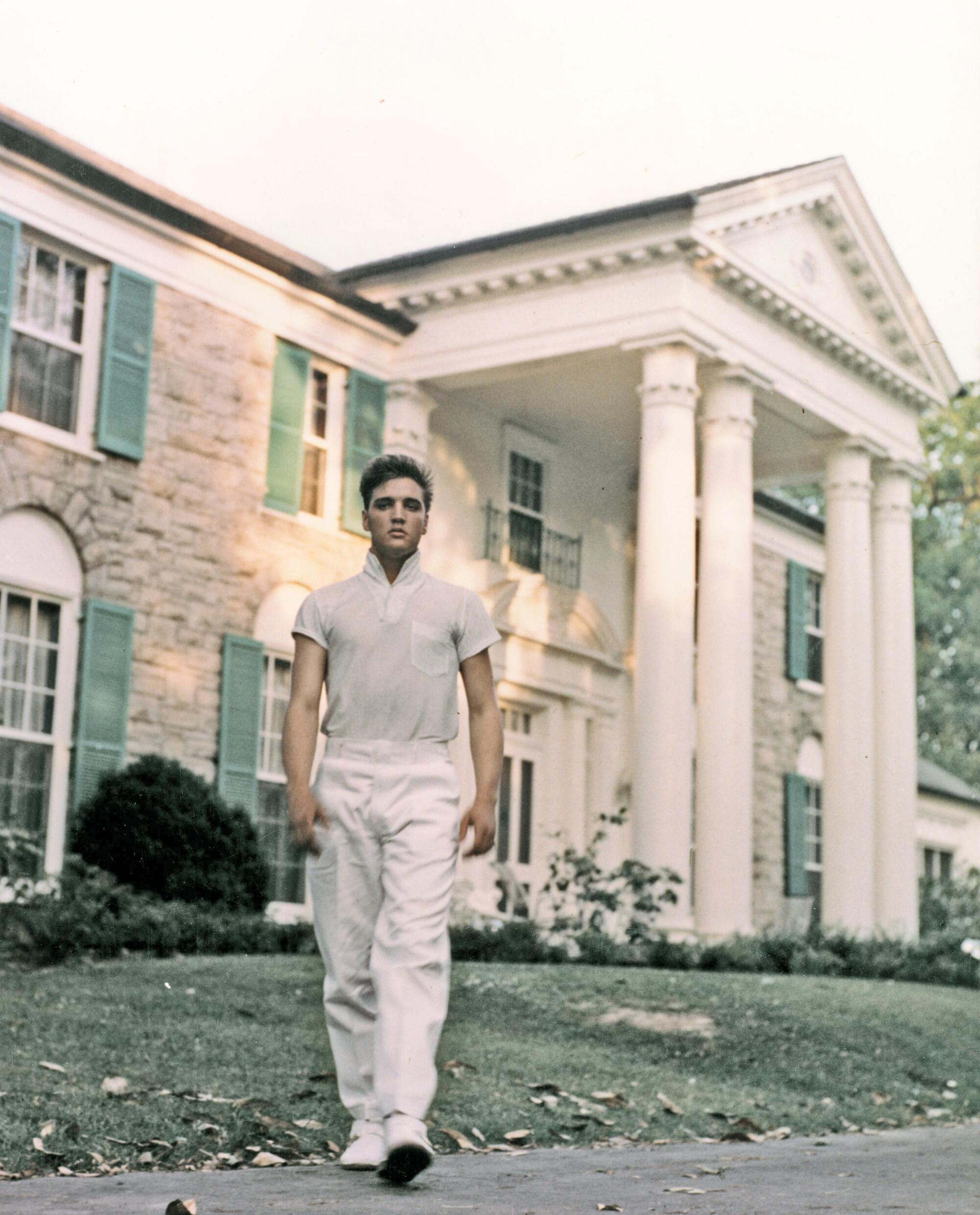 Elvis Presley strolls the grounds of his Graceland estate in circa 1957. 