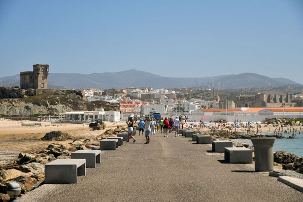 General view of people visiting Tarifa city showing mountain in the background