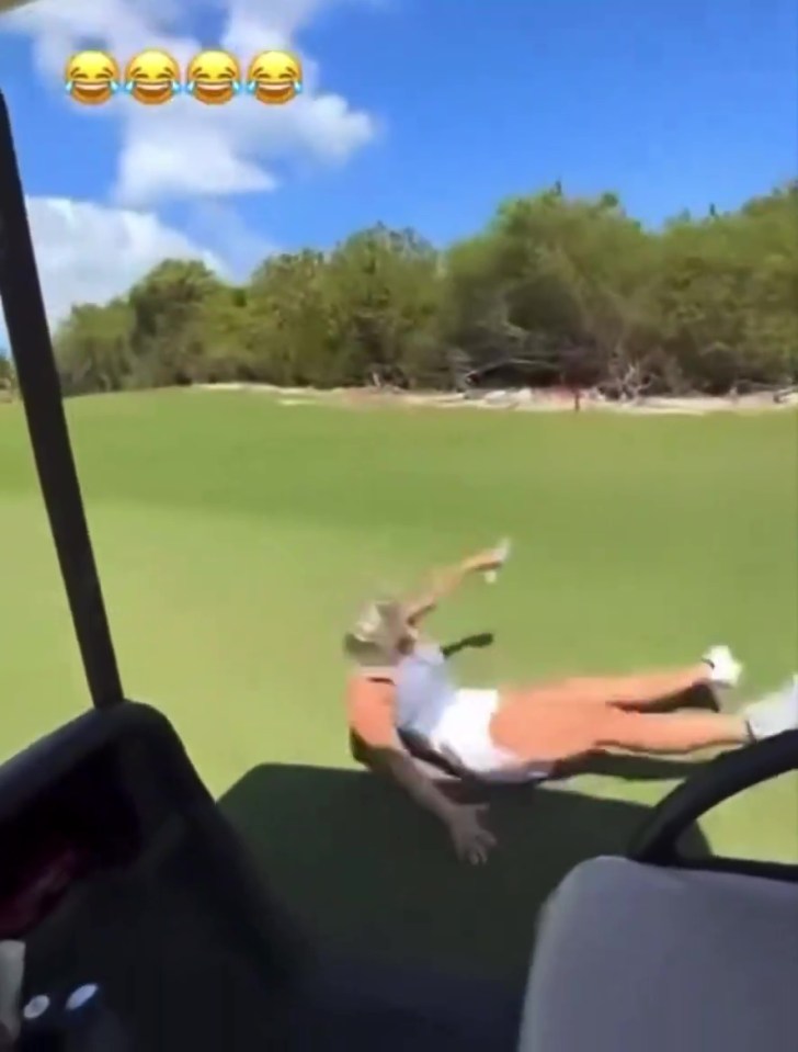Paige Spiranac falling out of a golf cart.
