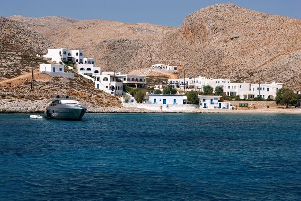 Image of Karavostasis from sea, showing whitewashed houses near shore