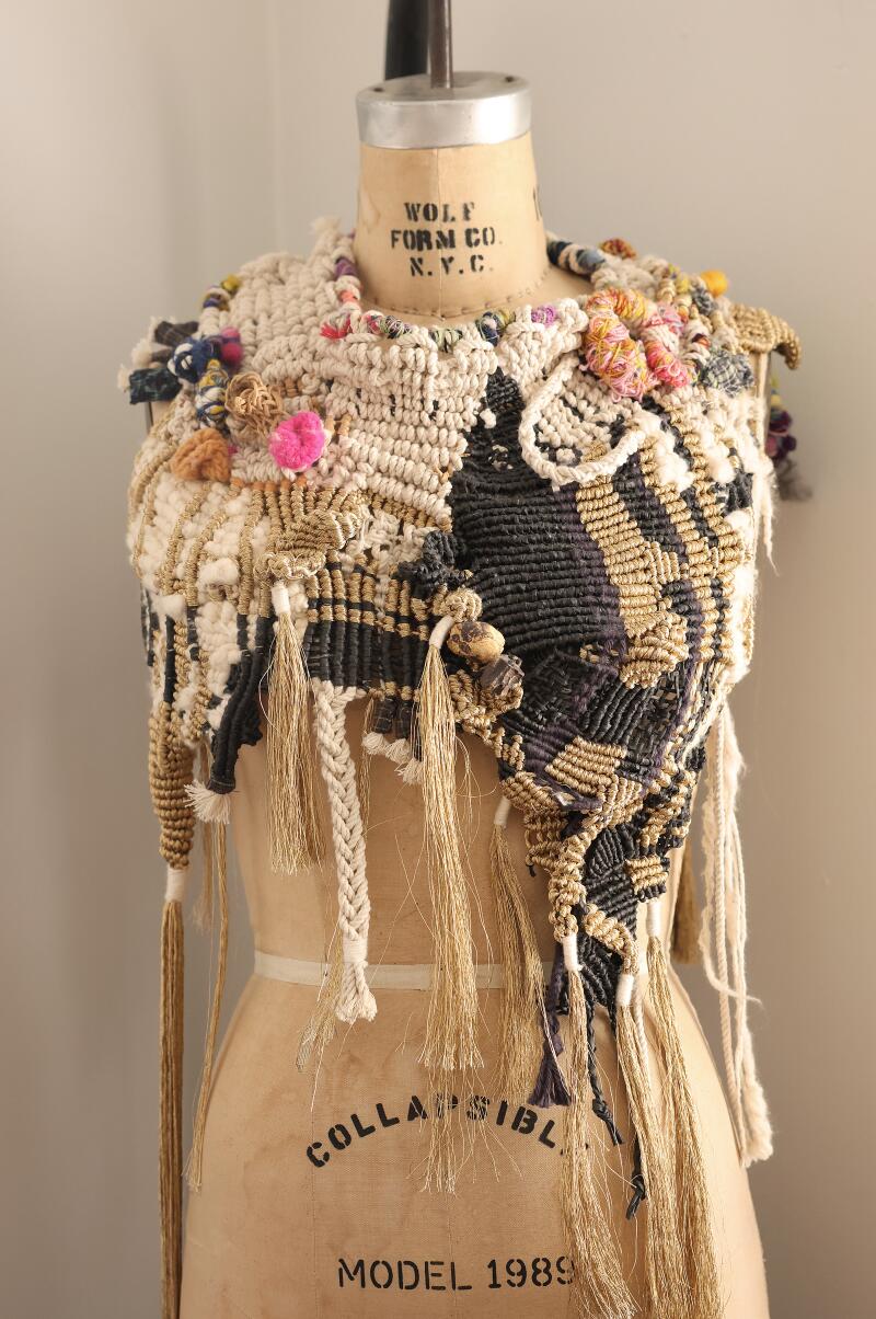 A knitted cowl on a mannequin