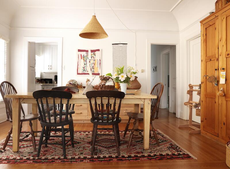A dining room with a wood table and chairs 