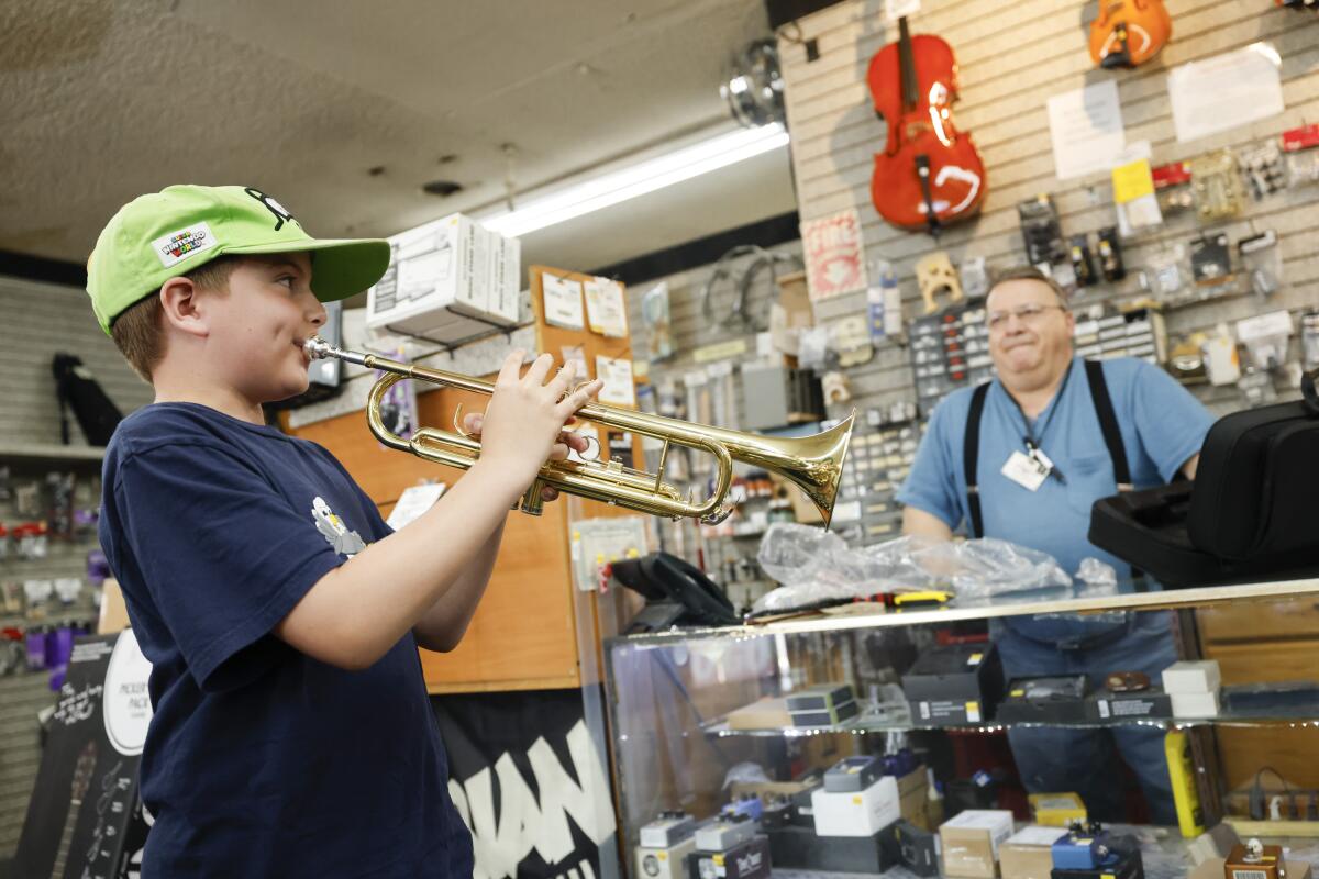 Walter Crawley plays the first notes of a new trumpet purchased at Cassell's Music.