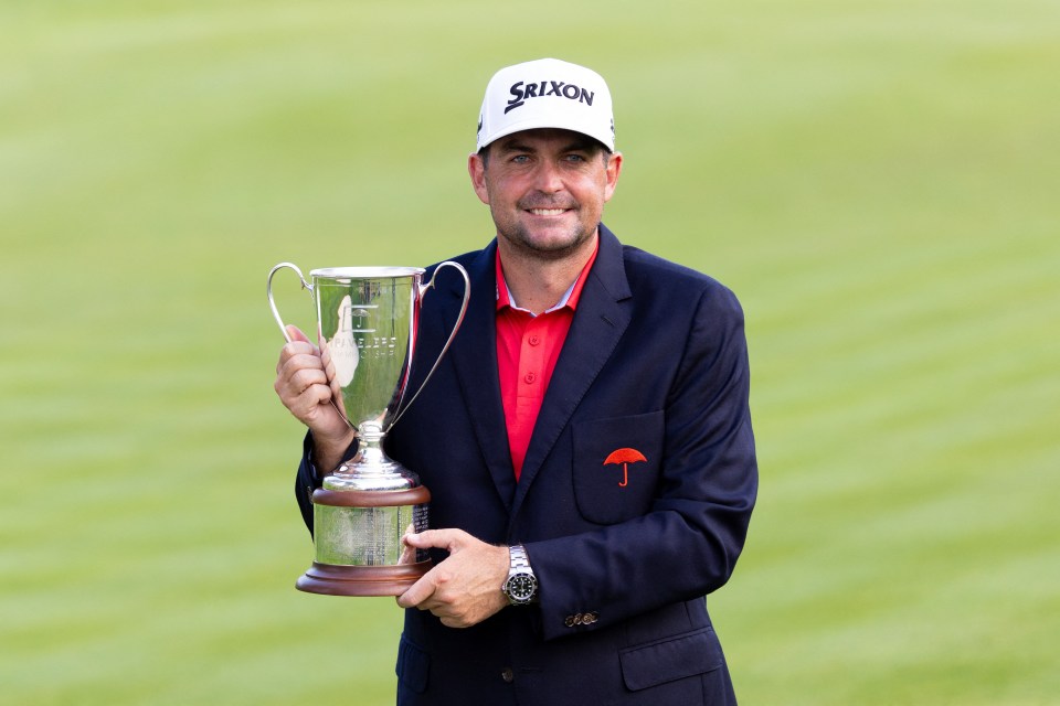 Keegan Bradley holding the Travelers Championship trophy.