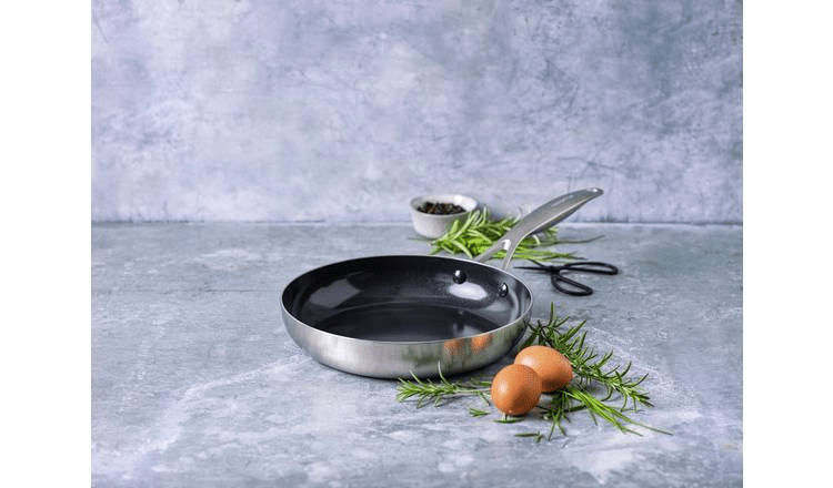 Frying pan with eggs and rosemary.