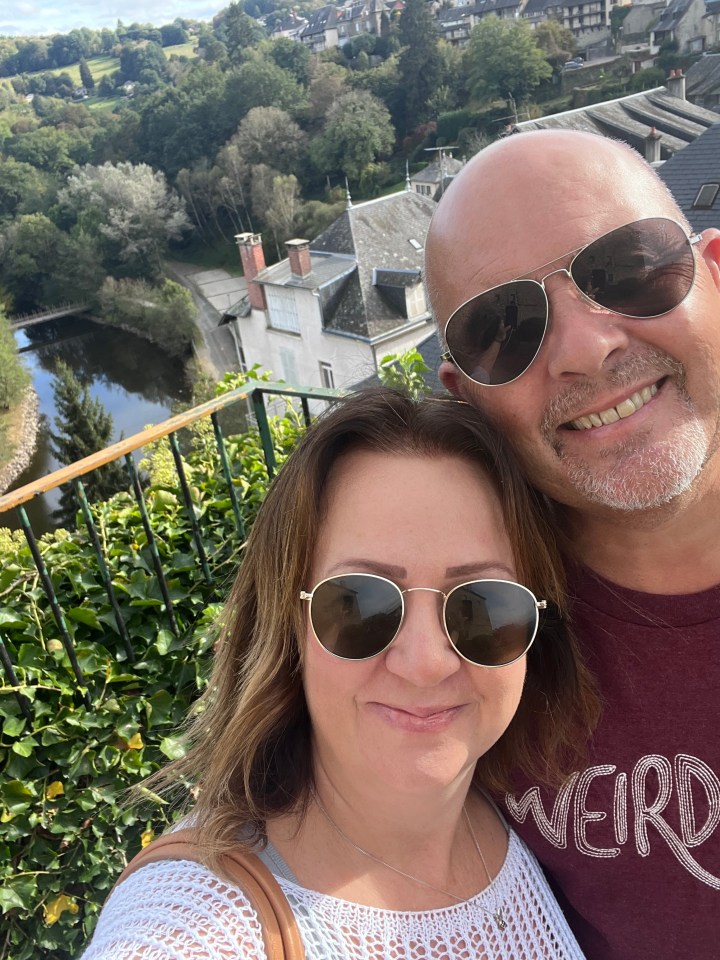 Selfie of a couple overlooking a French village.