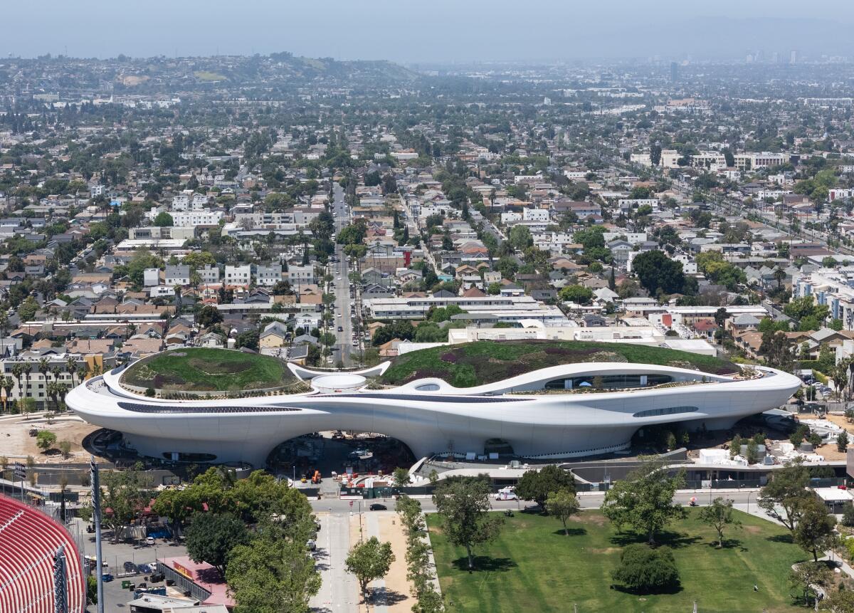 A spaceship-shaped building in an urban expanse.