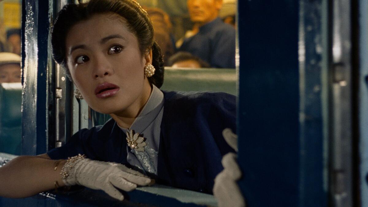 A woman looks out of a window.