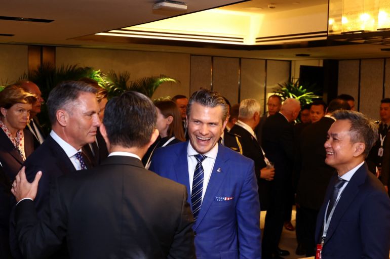men in suits talk at a reception