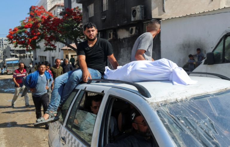 The body of a Palestinian is transported on a car as mourners attend the funeral of Palestinians who were killed, according to medics, in Israeli fire, at Al-Shifa hospital, in Gaza City, June 12, 2025. REUTERS/Mahmoud Issa TPX IMAGES OF THE DAY