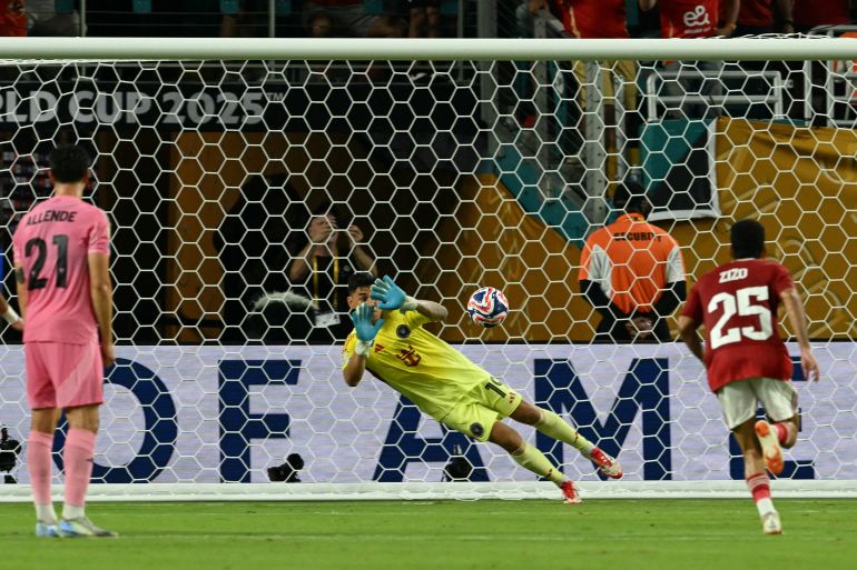 Inter Miami's Argentine goalkeeper #19 Oscar Ustari makes a save on a penalty kick by Al Ahly's Egyptian midfielder #07 Trezeguet