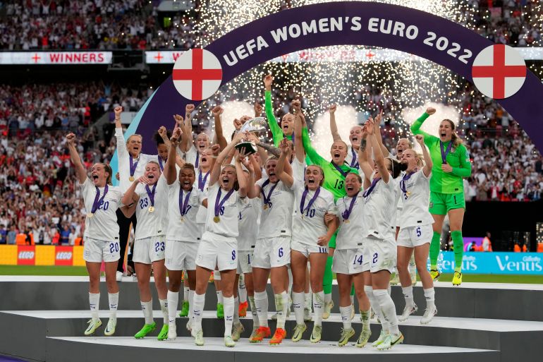 FILE - England's Leah Williamson, center left, and Millie Bright lift the trophy after winning the Women's Euro 2022 final soccer match between England and Germany at Wembley stadium in London, Sunday, July 31, 2022. Title holder England landed in a tough group with France, Sweden and Ireland in the qualifying draw for the 2025 European Championship in women's soccer. Euro 2022 winner England then reached the Women's World Cup final last year where Sweden was a semifinalist and France reached the quarterfinals. World Cup winner Spain will play Denmark, Belgium and the Czech Republic. (AP Photo/Alessandra Tarantino, File)