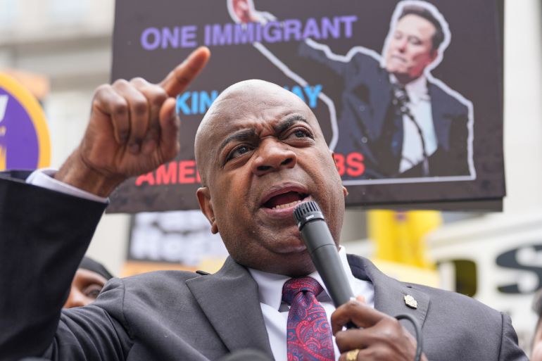 Ras Baraka speaks into a microphone at a protest.