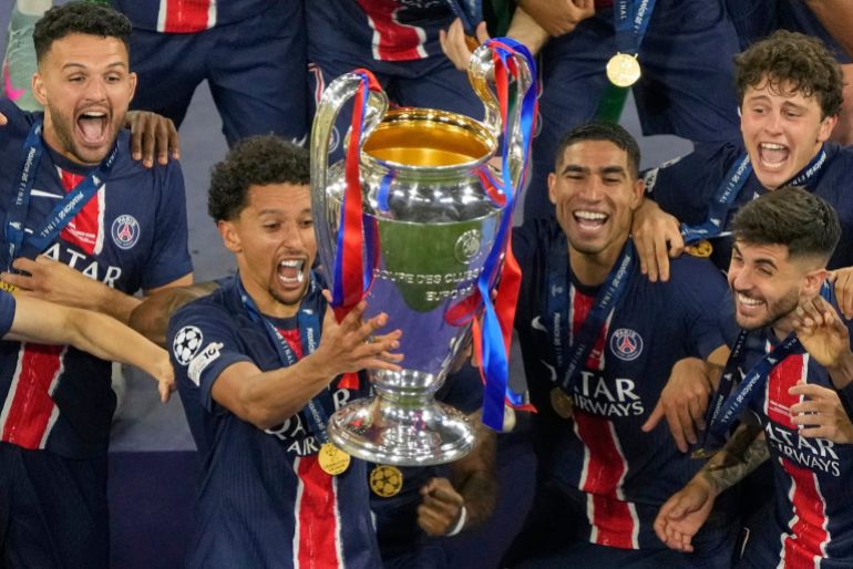 PSG players celebrate with the trophy after winning the Champions League final soccer match between Paris Saint-Germain and Inter Milan 