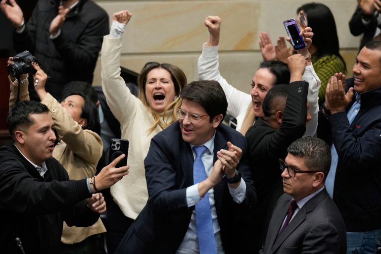 Miguel Uribe Turbay, center in blue tie, a Colombian senator and presidential candidate for the right-wing Centro Democrático party, celebrates after voting against a labor reform referendum proposed by the government, in Bogota, Colombia, May 14, 2025.