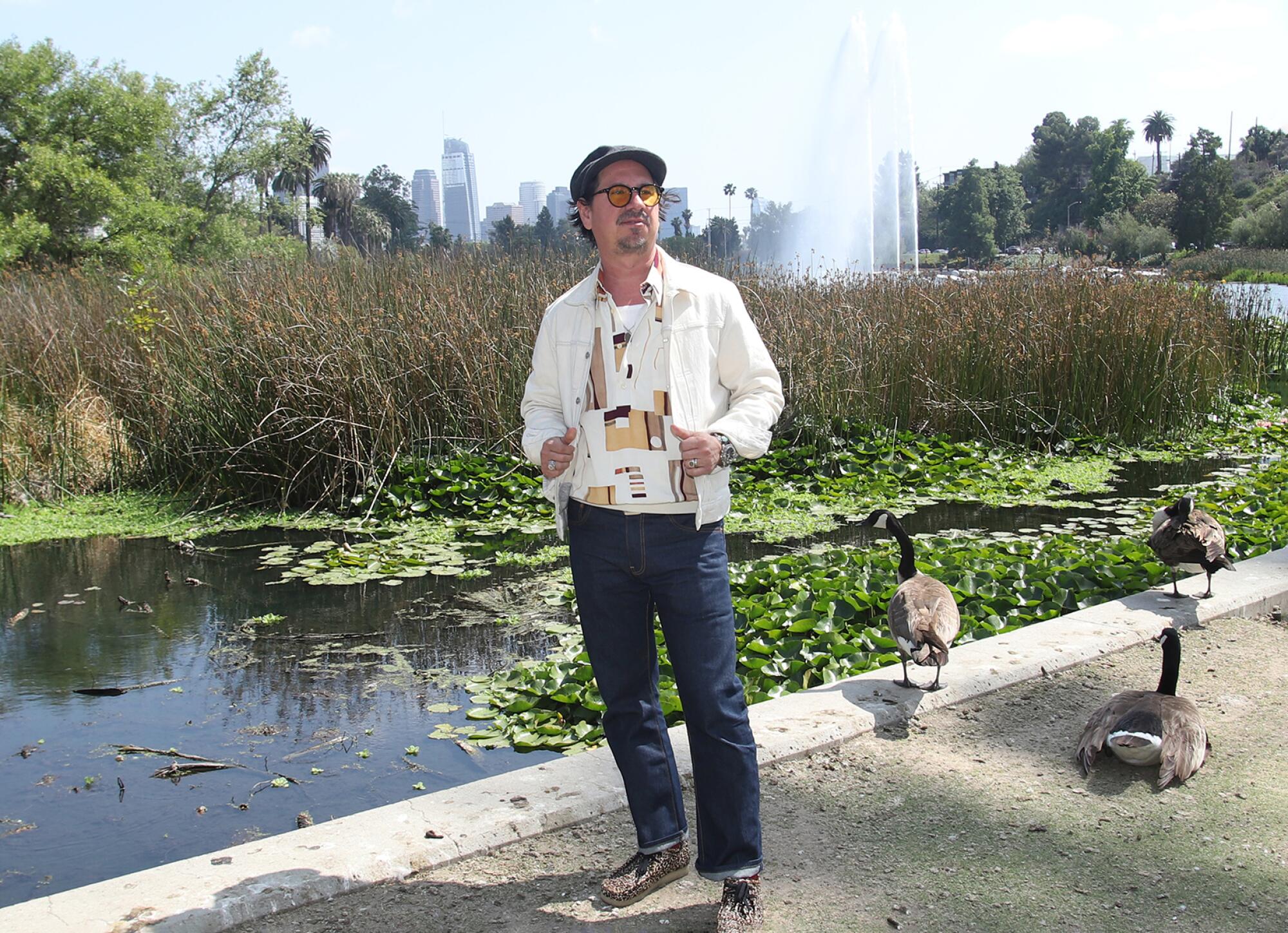 Musician Adrian Quesada poses for a picture at Echo Park Lake in Los Angeles on Sunday, May 18, 2025.