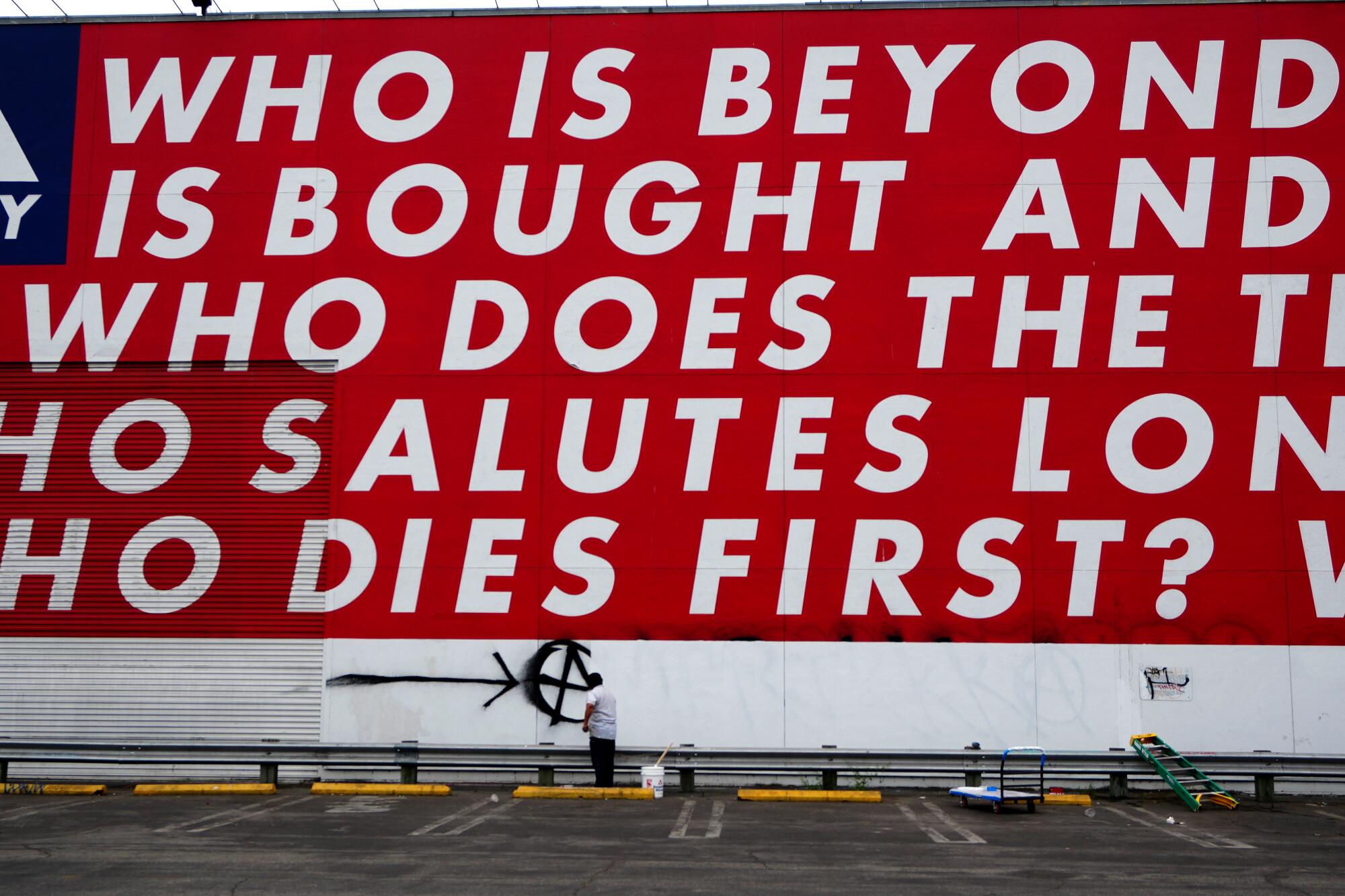 Big white words on a red wall.