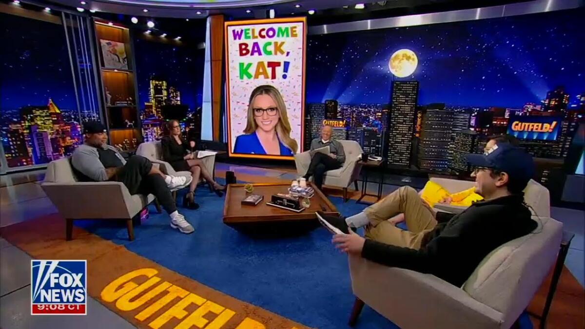 Tyrus, left, Kat Timpf, Greg Gutfeld, a hidden Kennedy and comedian Dave Angelo sit in a semi-circle on a TV show