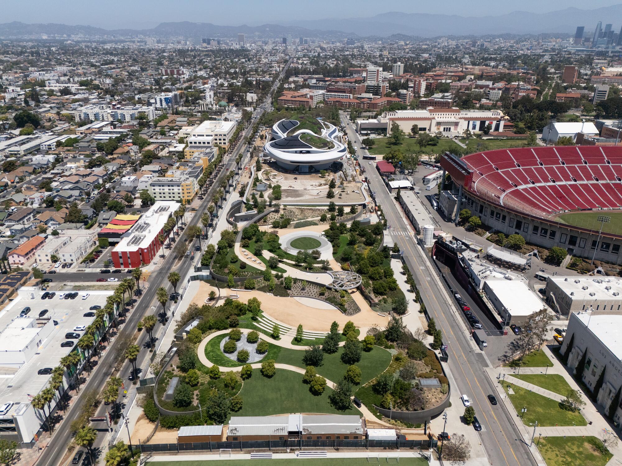 An aerial view of park space leading to the Lucas Museum of Narrative Art, next to the L.A. Coliseum.