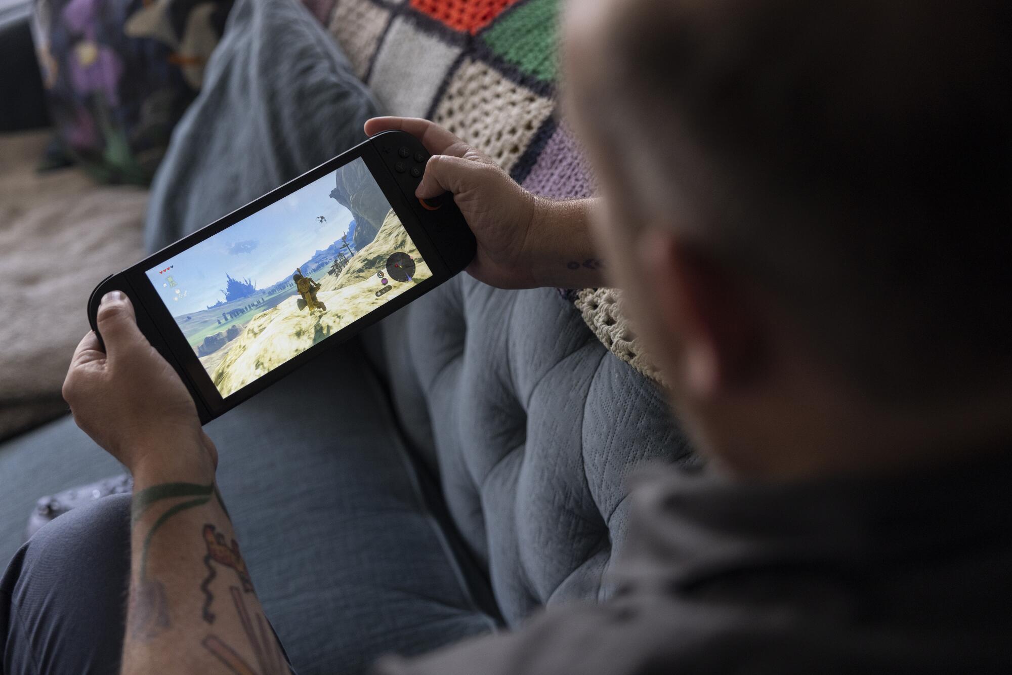 A Times writer holding a Nintendo Switch 2.