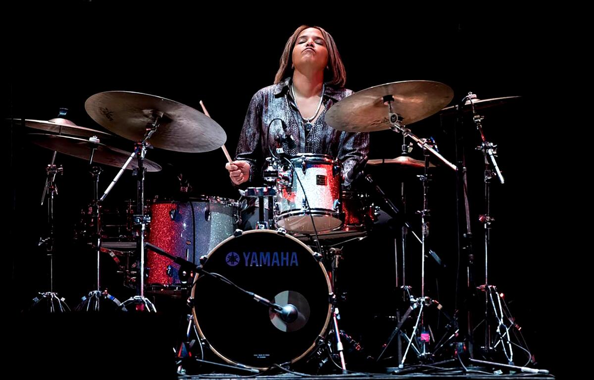Terri Lyne Carrington playing a drum kit.