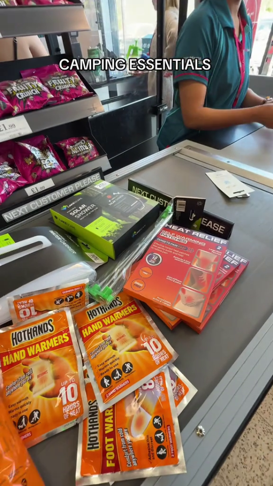 Camping essentials including hand and foot warmers on a checkout counter.