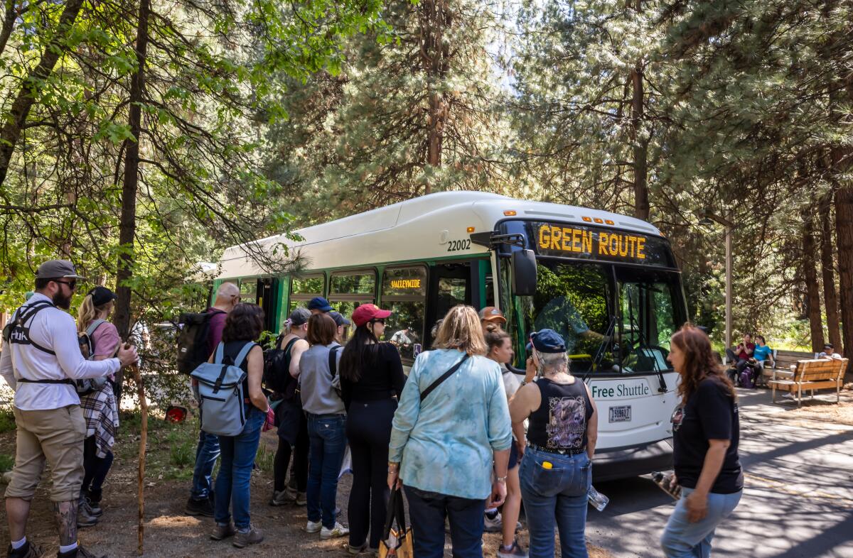 Visitors board buses in Yosemite National Park on May 20.