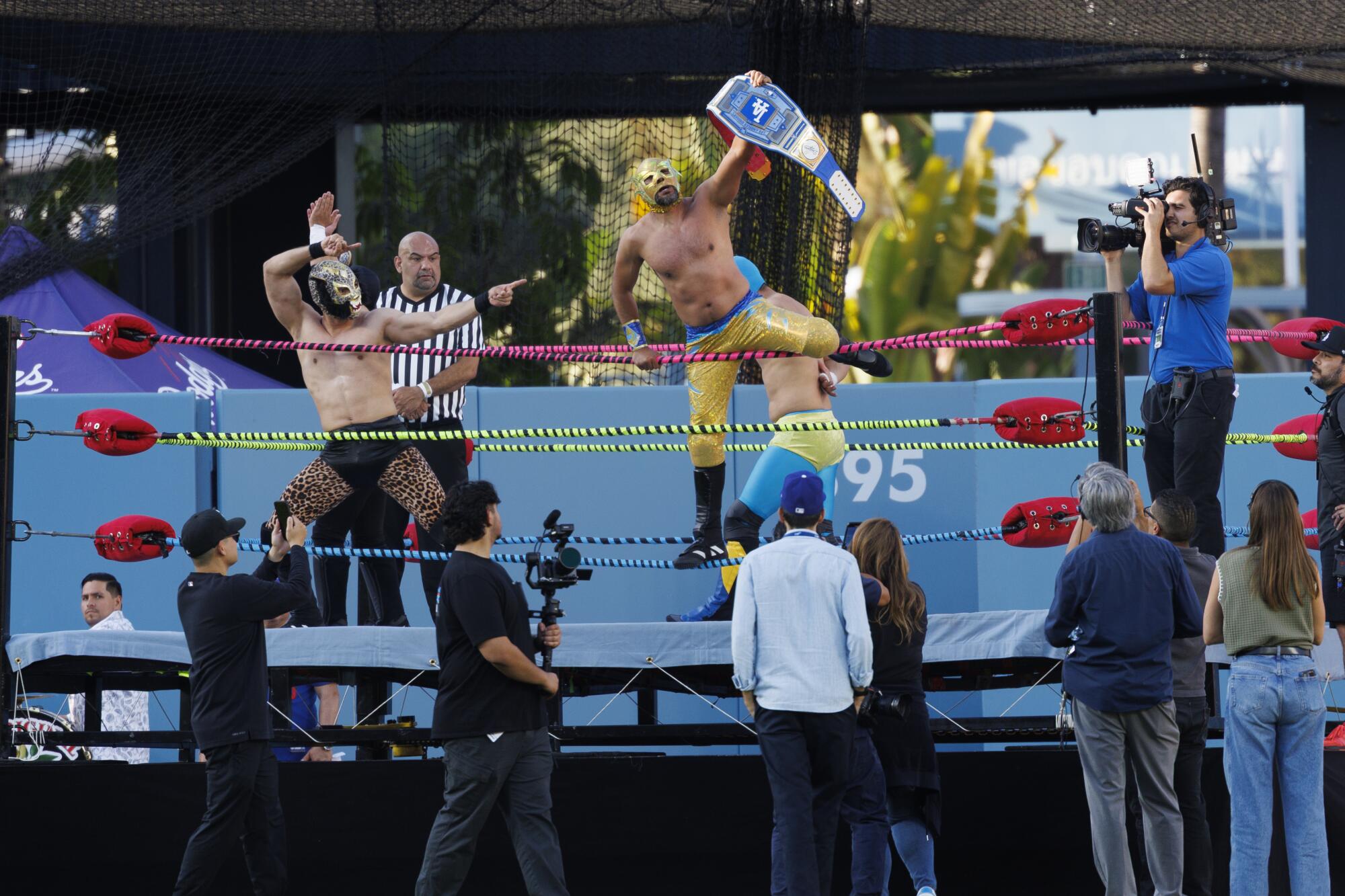 Lucha Libre perform in the outfield during Mexican Heritage night before the Dodgers game against the Arizona Diamondbacks
