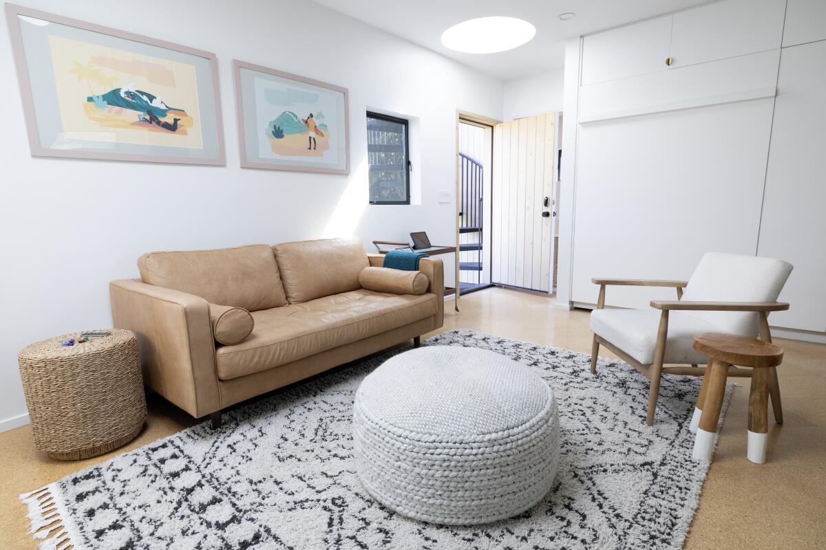 The living room of an ADU with white walls and skylight