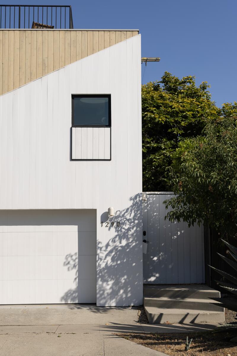Exterior of a two story ADU clad with white and cedar 