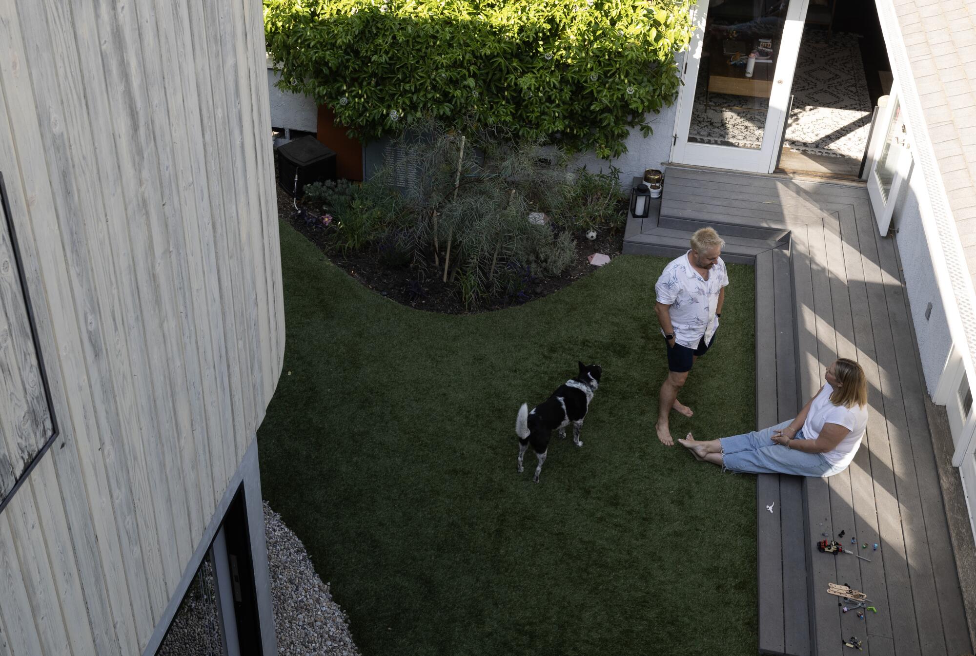 Will Burroughs and Frith Dabkowski sit on their lawn 