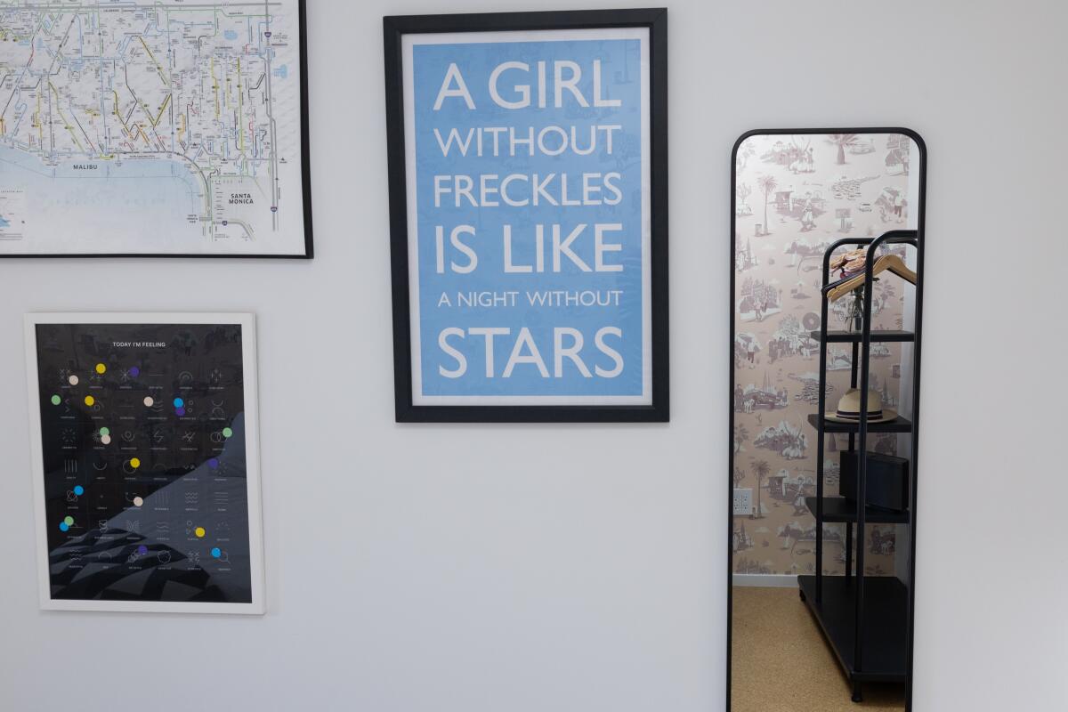 Posters and a mirror hang in the bedroom.