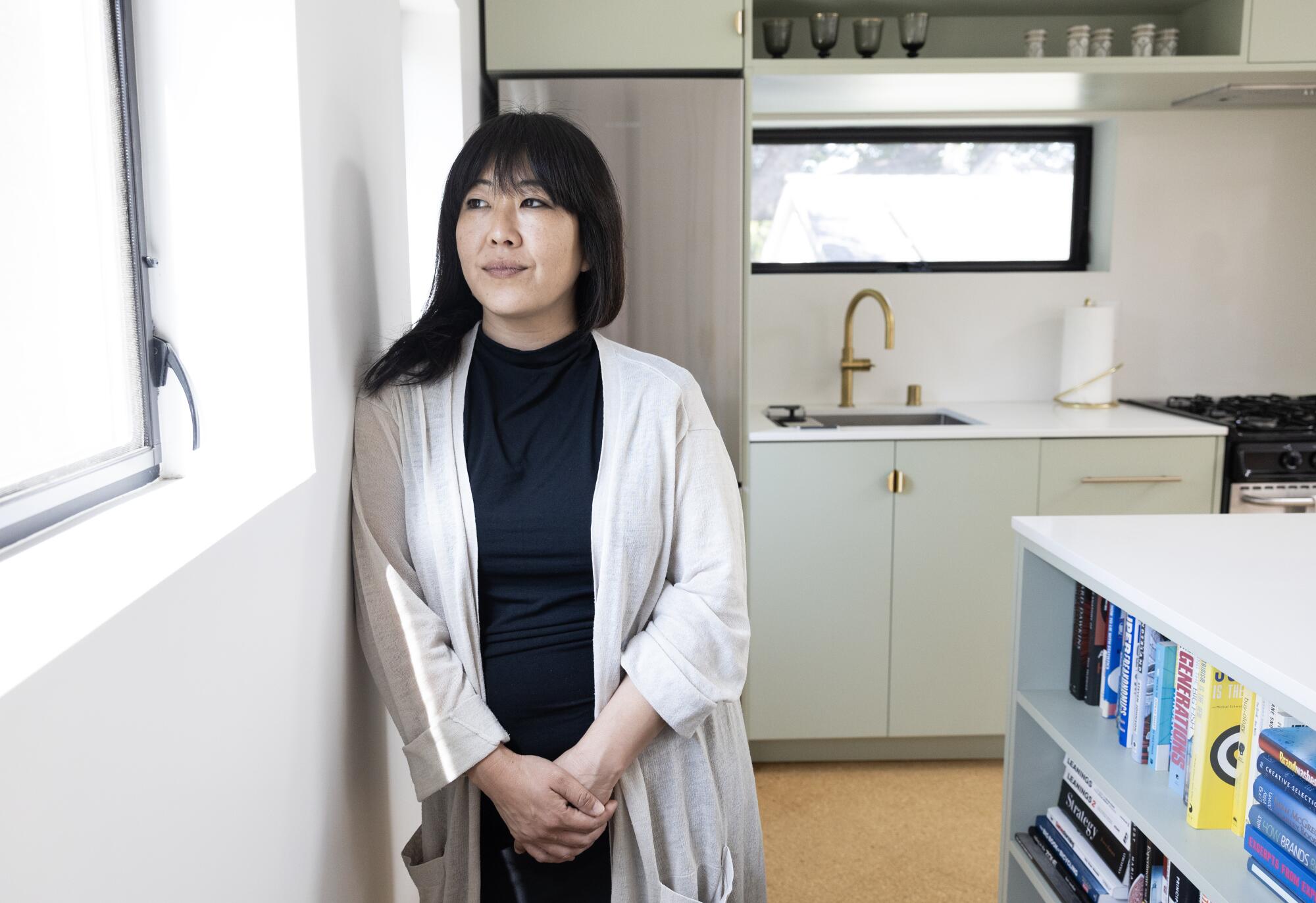 Architect Aejie Rhyu stands in the kitchen of the ADU 