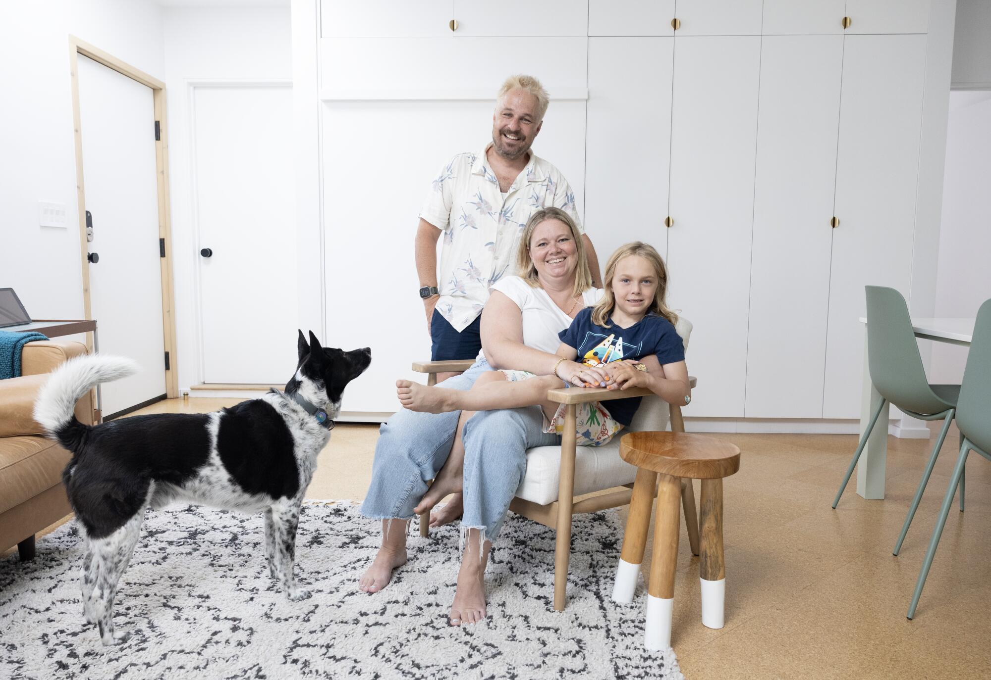 Will Burroughs and Frith Dabkowski sit in the living room two story ADU with their son Jack, 7, and family dog Banjo 