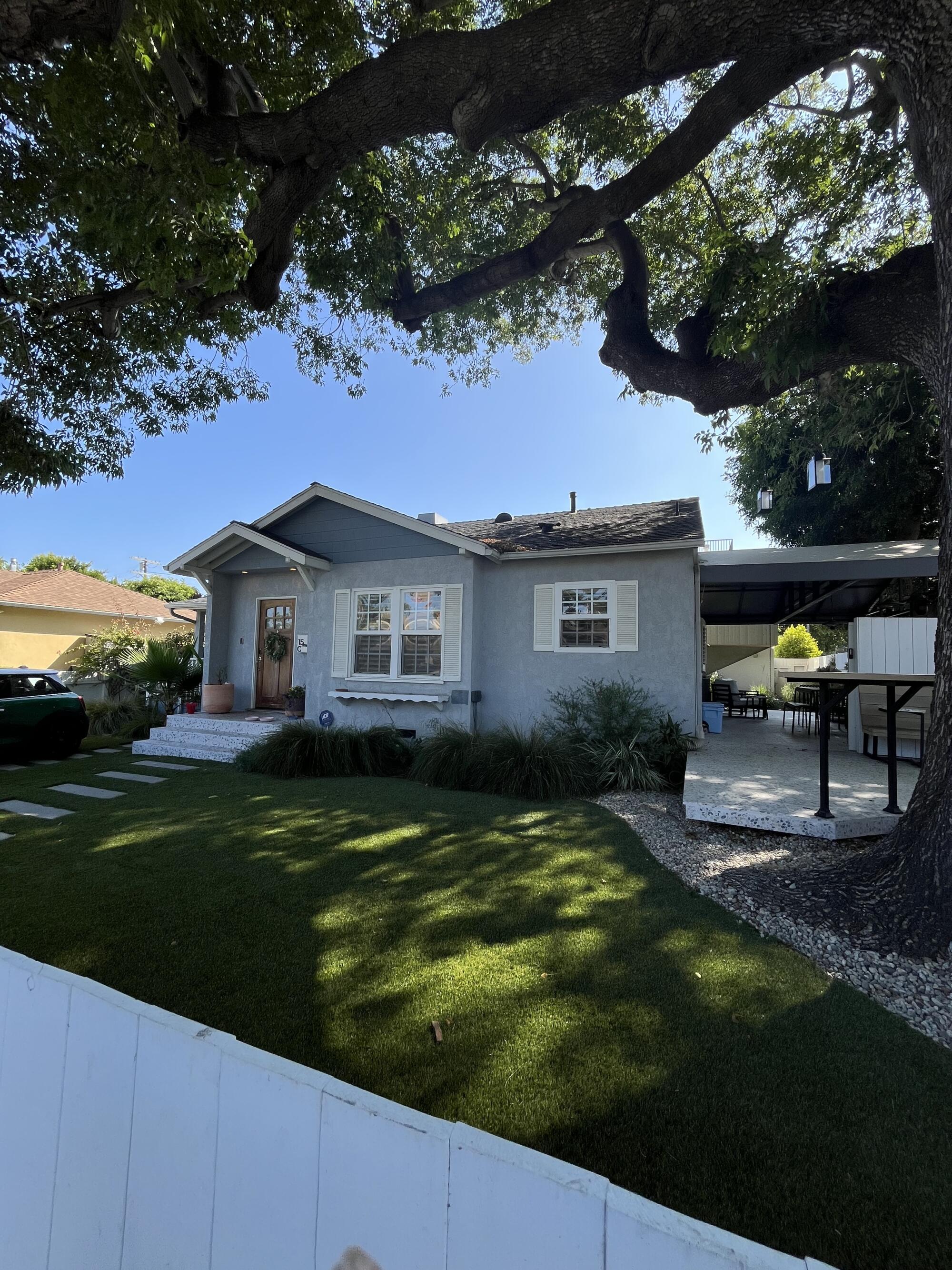 A traditional 1949 home under an ash tree