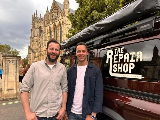 Dominic Chinea and Will Kirk stood in front of a van with the Repair Shop logo on it.