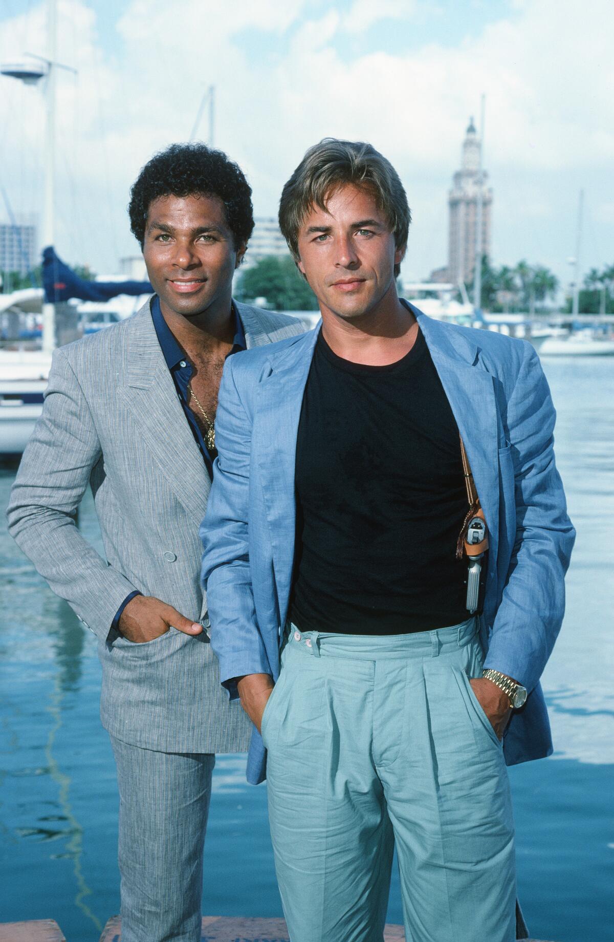 Two men in casual suits stand next to each other