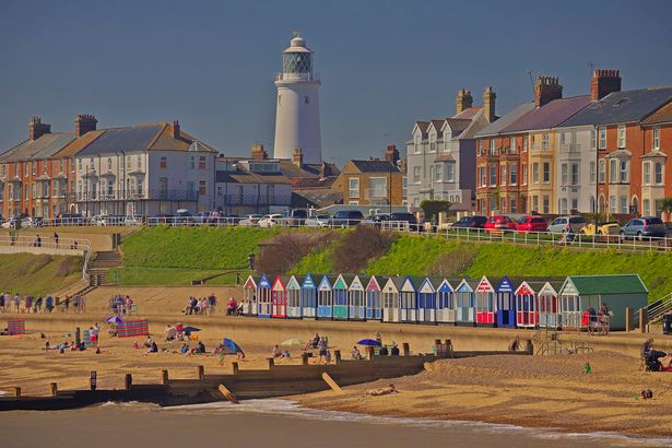 Houses, beach, lighthouse and clear skies