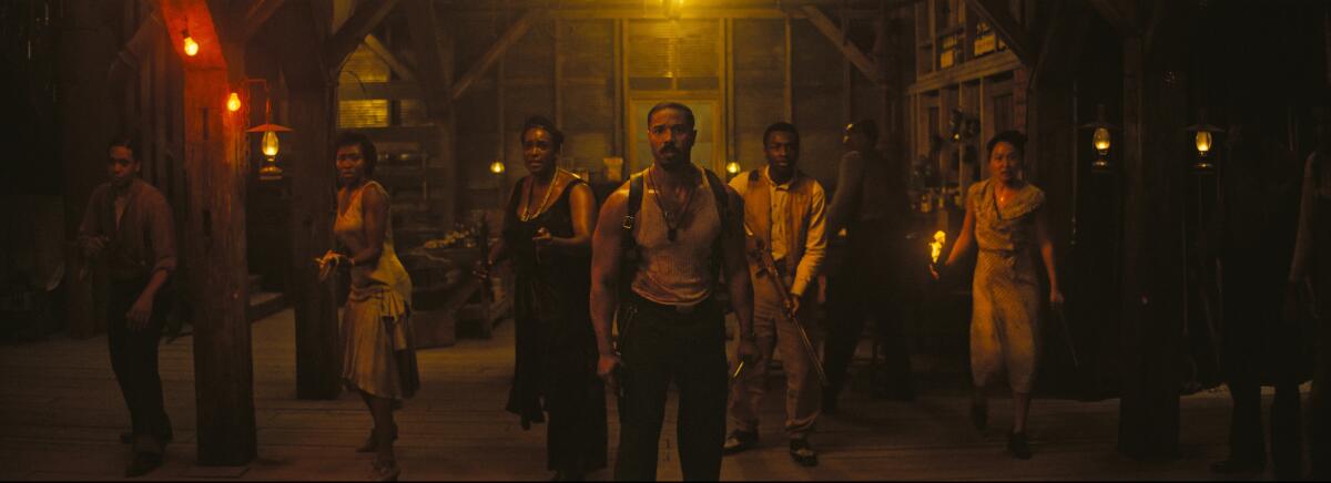 Several people brace with weapons for an invading horde of vampires.