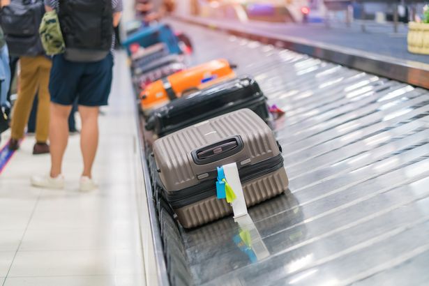 Suitcase or luggage on conveyor belt in the airport