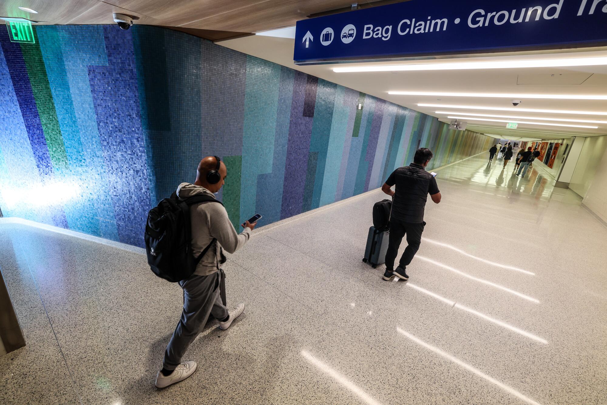 Tile mosaic wall designs line departure halls in various LAX terminals.