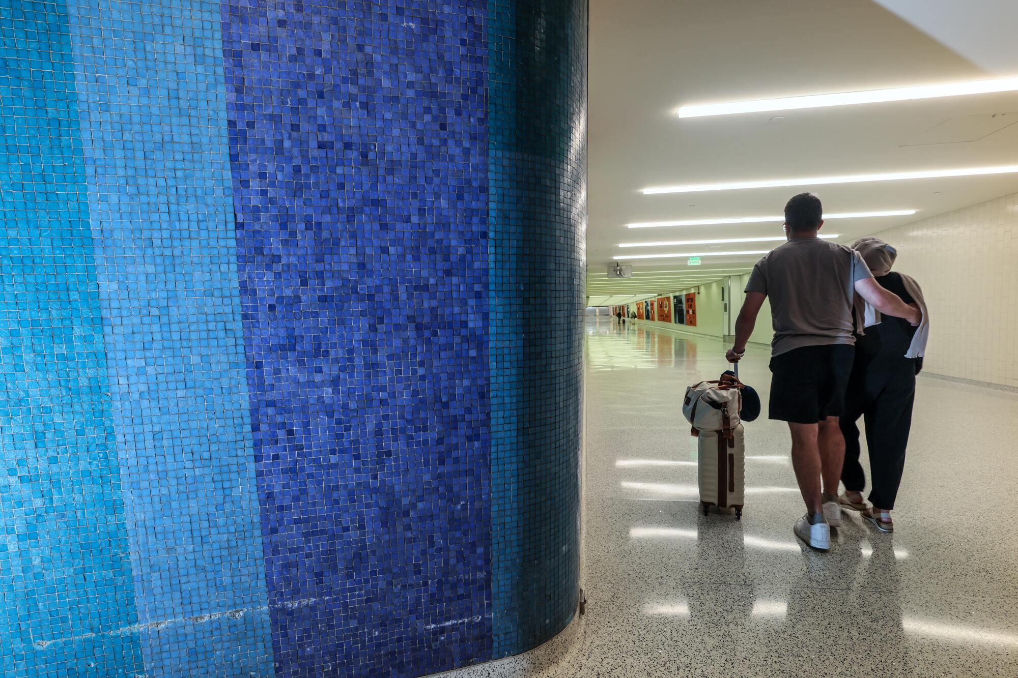 Tile mosaic wall designs line departure halls in various LAX terminals.