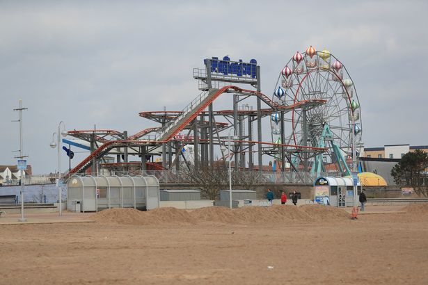 People walk past closed amusements on the beach front in Skegness, Lincolnshire, during England's third national lockdown to curb the spread of coronavirus. Picture date: Tuesday March 23, 2021. PA Photo. See PA story HEALTH Coronavirus. Photo credit should read: Mike Egerton/PA Wire