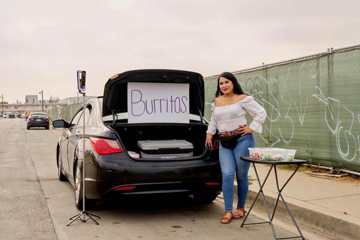 Maria Sanchez, known as "Maria la de los Burritos" sells $5 burritos in Watts out of the trunk of her car.