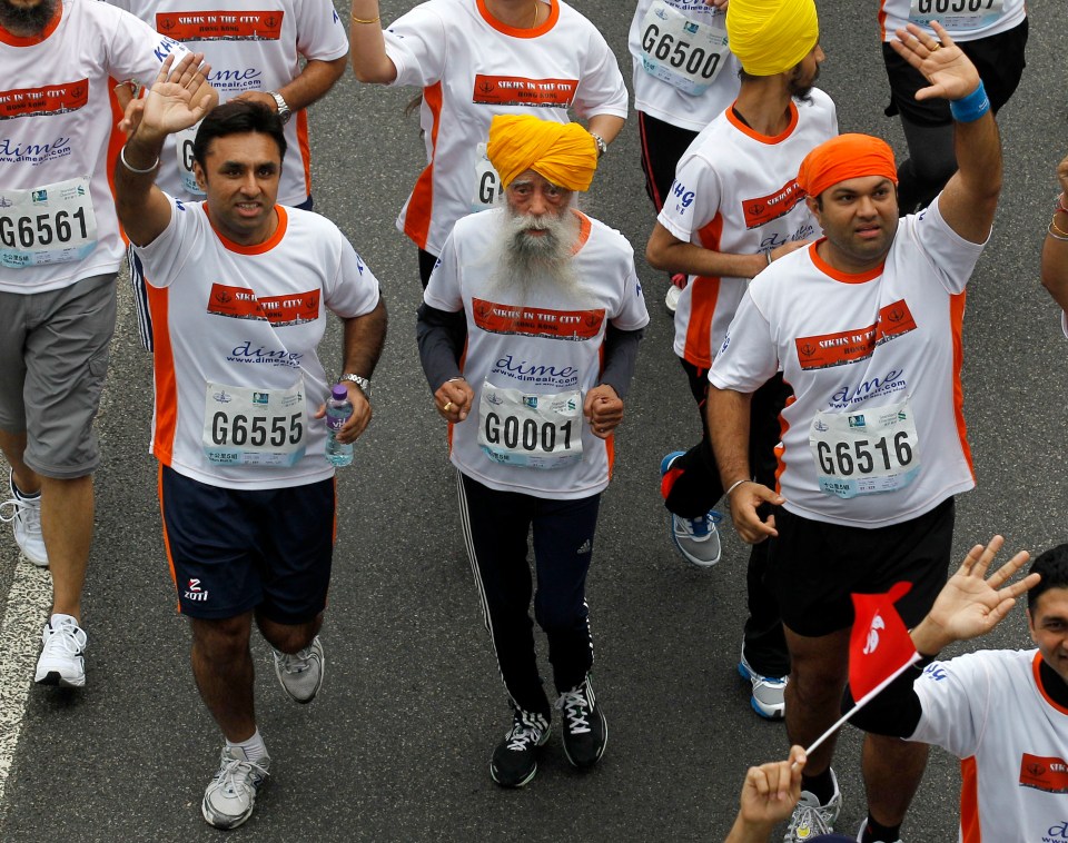 Centenarian Fauja Singh, center, competing in a 10k race.