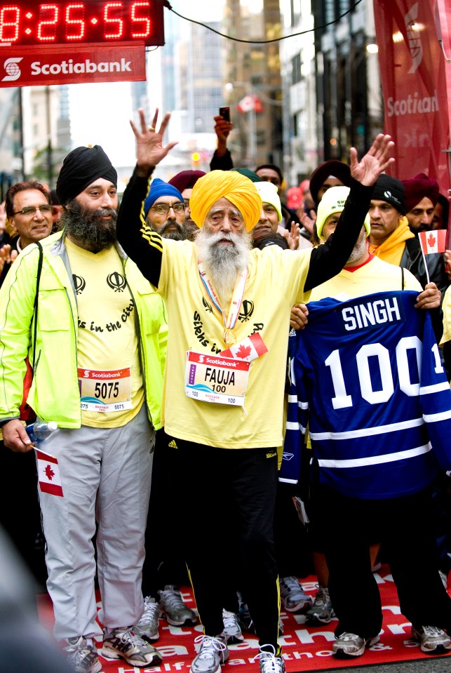 Fauja Singh, 100, celebrating after completing a marathon.